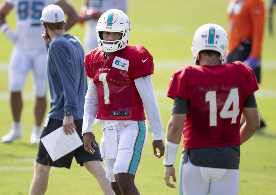 Dolphins QBs Tua Tagovailoa (1) and Ryan Fitzpatrick during training camp in 2020.