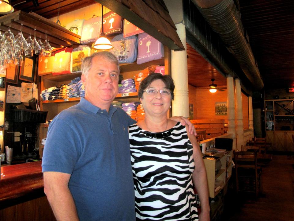 Sammy Rhodes and his sister, Donna Rhodes Hiott, pose inside Sullivan's, their family-owned seafood restaurant on Sullivans Island, S.C., on Sept. 12, 2013. The restaurant is one of about a dozen on Sullivans Island just outside Charleston, S.C. (AP Photo/Bruce Smith)