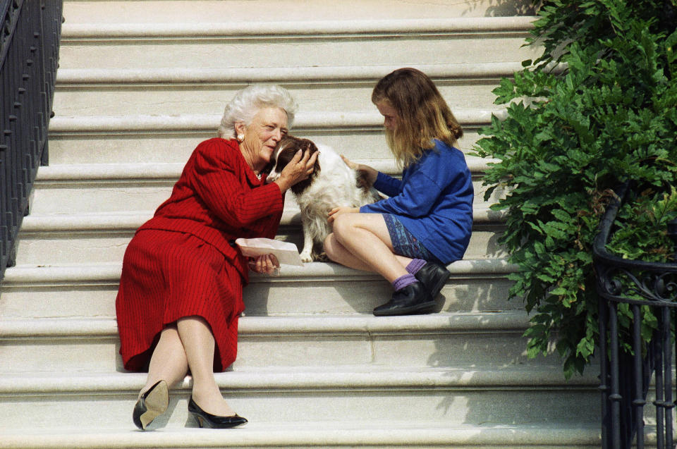 FILE - In this Sept. 13, 1991, file photo, first lady Barbara Bush, her granddaughter Barbara, and Millie wait on the steps of the White House for President George H.W. Bush to return from his check-up at Bethesda Naval Hospital in Washington. Pets are back at the White House. President Joe Biden's German shepherds Champ and Major moved in over the weekend. They are the first dogs to live at the executive mansion since the Obama administration. Biden and his wife, Jill, adopted Major in 2018 from the Delaware Humane Association. They got Champ after the 2008 election. (AP Photo/Barry Thumma, File )