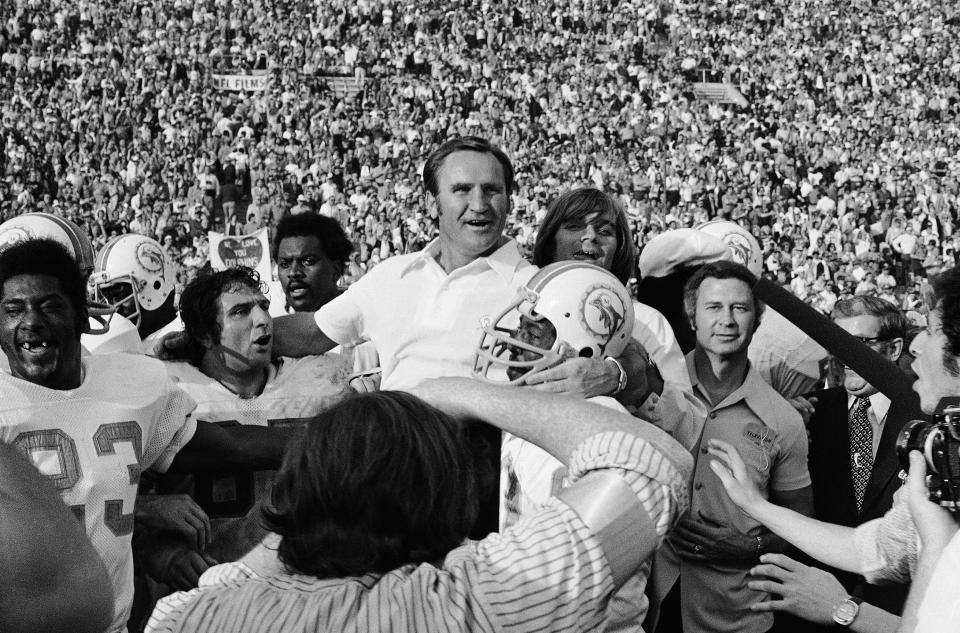 FILE - Miami Dolphins head coach Don Shula, center, is carried off the field after his team won the NFL football Super Bowl game over the Washington Redskins in Los Angeles, Jan. 14, 1973. It's quite likely no other Miami team will ever live up to that perfect '72 Dolphins team. That team has almost taken a larger-than-life meaning in the hearts and minds of sports fans. What that team did 50 years ago was difficult enough, but in today's NFL it's a nearly unattainable feat. (AP Photo/File)
