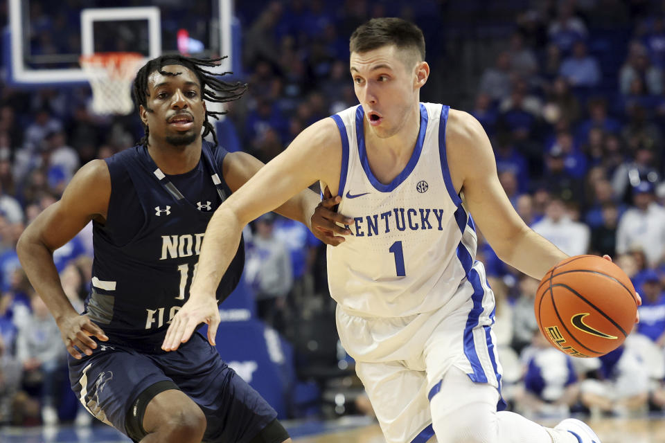 Kentucky's CJ Fredrick (1) drives on North Florida's Jarius Hicklen (10) during the first half of an NCAA college basketball game in Lexington, Ky., Wednesday, Nov. 23, 2022. (AP Photo/James Crisp)