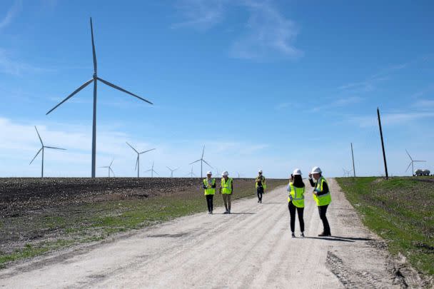 PHOTO: Employees walk down a road for a closer look at wind turbines during a tour for the dedication of the Limestone Wind Project in Dawson, Texas, Feb. 28, 2023. (Mark Felix/AFP via Getty Images, FILE)