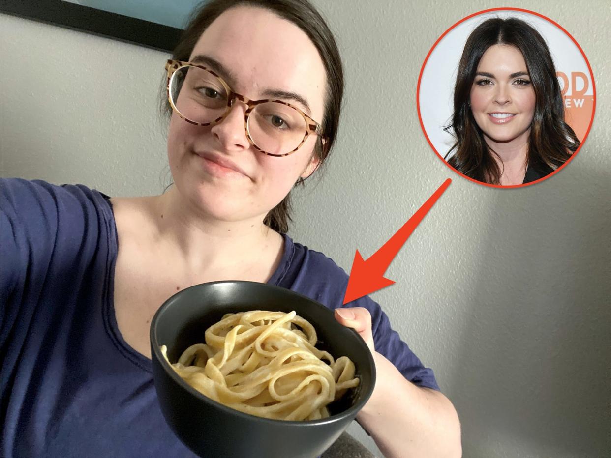 The writer holding a bowl of pasta that has a photo of Katie Lee Beigel and an arrow pointing toward it