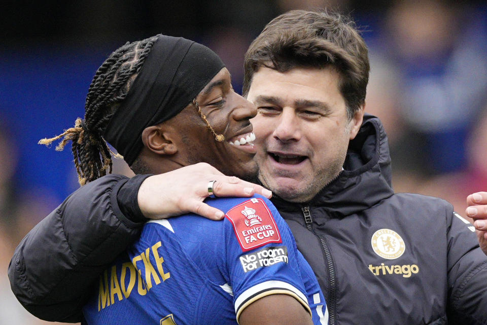 Chelsea's head coach Mauricio Pochettino celebrates with Chelsea's Noni Madueke after the FA Cup quarterfinal soccer match between Chelsea and Leicester City at Stamford Bridge in London, Sunday, March 17, 2024. Chelsea won the match 4-2. (AP Photo/Dave Shopland)