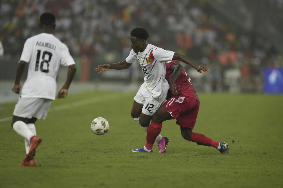 Equatorial Guinea's Basilio Ndong challenges Guinea's Ibrahima Diakite during the African Cup of Nations Round of 16 soccer match between Equatorial Guinea and Guinea, at the Olympic Stadium of Ebimpe in Abidjan, Ivory Coast, Sunday, Jan. 28, 2024. (AP Photo/Themba Hadebe)