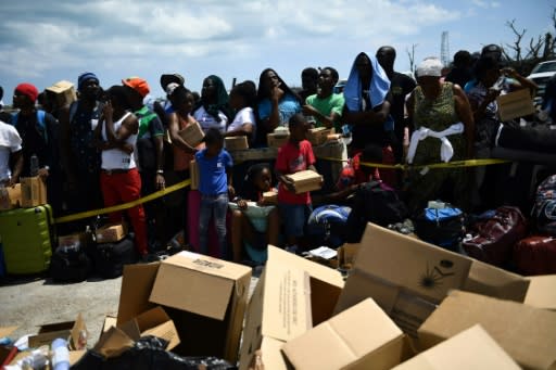 People await evacuation at a dock in Marsh Harbour, Bahamas, on September 7, 2019, in the aftermath of Hurricane Dorian