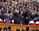 FILE PHOTO: North Korean leader Kim Jong-Un (C), his wife Ri Sol-Ju (L) and former NBA basketball player Dennis Rodman clap during an exhibition basketball game in Pyongyang in this undated picture released by North Korea's KCNA news agency on March 1, 2013. REUTERS/KCNA/File photo