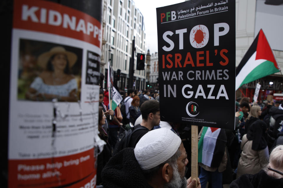 A damaged poster on a lamppost shows an image of Israeli citizens who have allegedly been kidnapped by the militant group Hamas, during a pro-Palestinian demonstration in London, Saturday, Oct. 21, 2023. (AP Photo/David Cliff)
