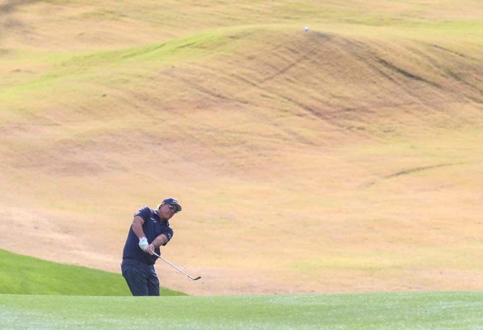 Phil Mickelson takes a shot from off the 11th green landing inches from the cup on the Pete Dye Stadium course during the third round of The American Express at PGA West in La Quinta, Calif., Saturday, Jan. 22, 2022.