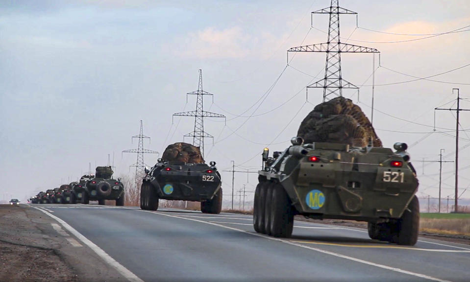 This photo made from the footage provided by Russian Defense Ministry press service on in Tuesday, Nov. 10, 2020 shows Russian military vehicles carry peacekeepers on their way to an airport in unknown place in Russia. Scores of Russian peacekeepers were heading to Nagorno-Karabakh on Tuesday morning, hours after Armenia and Azerbaijan agreed to halt the fighting over the separatist region in a pact signed with Moscow which envisions the deployment of nearly 2,000 Russian peacekeepers and territorial concessions. (Russian Defense Ministry Press Service via AP)