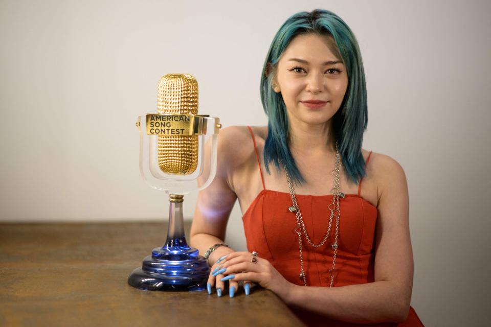 In this photo taken on June 21, 2022, Korean-American K-pop star AleXa, who recently won the American Song Contest, poses with her trophy in a dance studio of South Korea's ZB Label in Seoul.