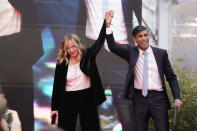 Italy's Prime Minister Giorgia Meloni, left, and Britain's Prime Minister Rishi Sunak cheer as they leave the annual political festival Atreju, organized by the Giorgia Meloni's Brothers of Italy political party, in Rome, Saturday, Dec. 16, 2023. (AP Photo/Alessandra Tarantino)