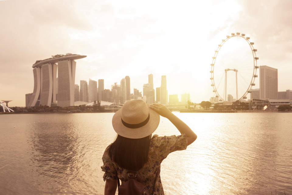 Tourist woman is enjoy traveling at Singapore with famous landmark view. Photo: Getty