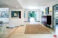 <p>Inside, the home boats modern decor including wood floors. (Realtor.com) </p>