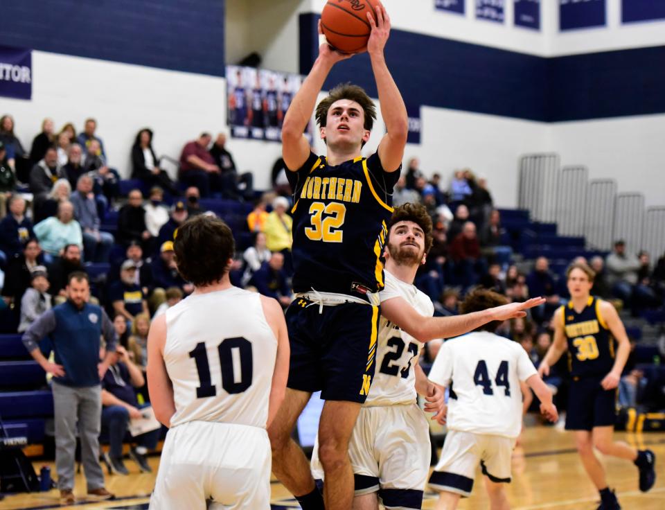 Port Huron Northern's Tyler Jamison pulls up for a jump shot during a game last season. He led all scorers with 29 points in the Huskies' 60-56 win over Croswell-Lexington on Saturday.