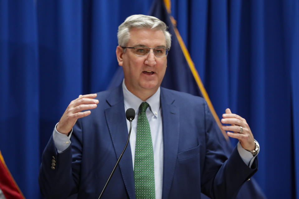 FILE - In this March 24, 2020 file photo, Indiana Gov. Eric Holcomb answers questions at the Statehouse in Indianapolis. Seven Midwestern governors announced Thursday, April 16, 2020 that they will coordinate on reopening their state economies amid the coronavirus pandemic, after similar pacts were made in the Northeast and on the West Coast. The latest agreement includes Illinois, Ohio, Michigan, Indiana, Wisconsin, Minnesota and Kentucky. (AP Photo/Michael Conroy File)