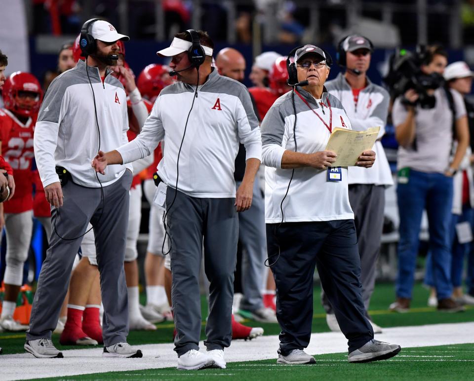 Coach Denney Faith looks up to the game clock during Wednesday's UIL Class 2A Div. 2 state football championship against Mart.