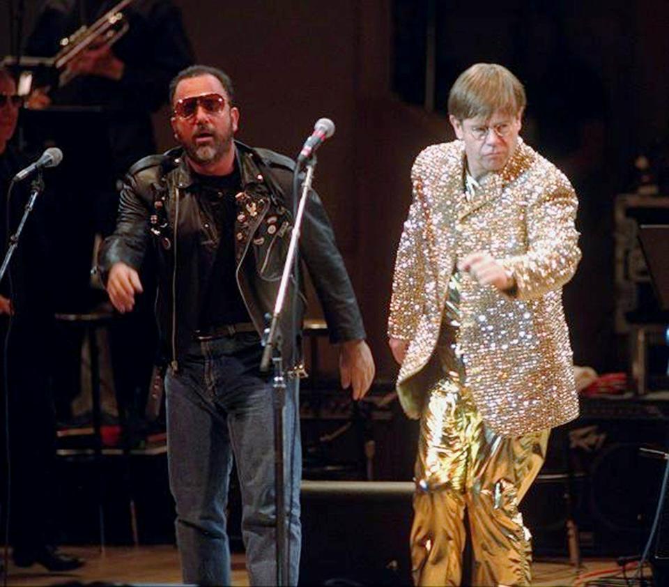 Billy Joel (left) and John performing at a benefit concert for the Rain Forest Foundation International at New York's Carnegie Hall.