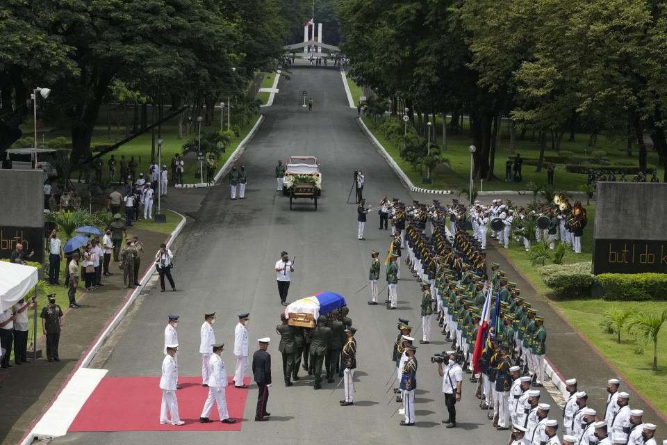 Soldiers carry the flag-draped casket of the late former Philippine President Fidel Ramos during his state funeral at the Heroes' Cemetery in Taguig, Philippines on Tuesday Aug. 9, 2022. Ramos was laid to rest in a state funeral Tuesday, hailed as an ex-general, who backed then helped oust a dictatorship and became a defender of democracy and can-do reformist in his poverty-wracked Asian country. (AP Photo/Aaron Favila)