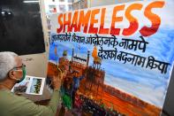 A school teacher paints a depiction of the Red Fort to condemn the violence a day after farmers went on the rampage in the capital, leaving one person dead and dozens injured, in Mumbai on January 27, 2021. (Photo by INDRANIL MUKHERJEE / AFP) (Photo by INDRANIL MUKHERJEE/AFP via Getty Images)