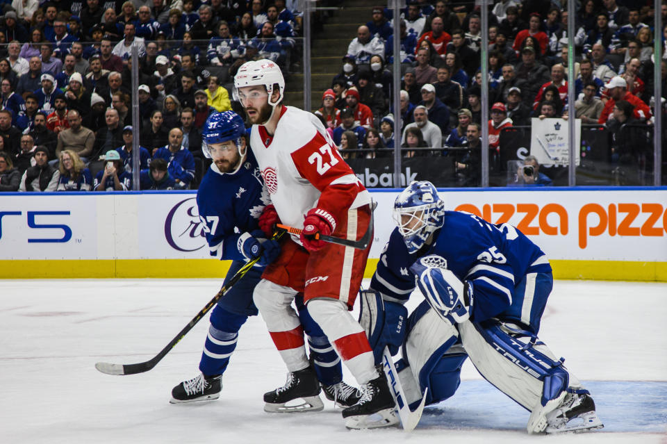 Detroit Red Wings center Michael Rasmussen (27) fights for position with Toronto Maple Leafs defenseman Timothy Liljegren (37) and goaltender Ilya Samsonov (35) during the third period of an NHL hockey game Saturday, Jan. 7, 2023, in Toronto. (Christopher Katsarov/The Canadian Press via AP)