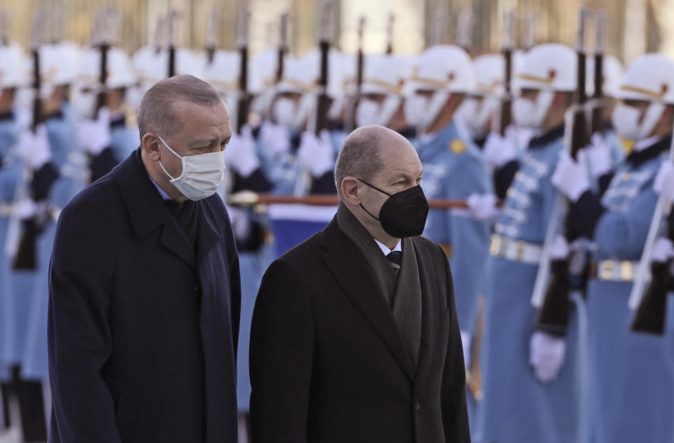 Turkish President Recep Tayyip Erdogan, left, and Germany's Chancellor Olaf Scholz review a military honour guard during a ceremony in Ankara, Turkey, Monday, March 14, 2022. Scholz is visiting Turkey Monday in his first official trip to the country since he took office in December. He will hold talks with Turkish President Recep Tayyip Erdogan in Ankara.(AP Photo/Burhan Ozbilici)