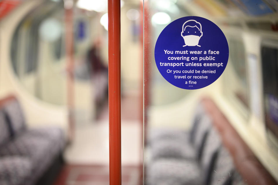 LONDON, ENGLAND - MARCH 26: A sign stating that face masks must be worn is seen inside a near-empty underground train carriage on March 26, 2021 in London, England. A year after the first Covid-19 lockdown discouraged use of public transit, ridership on the London Underground, which recorded around 4 million rides every weekday pre-pandemic, is hovering around 20 percent of normal. Transport for London worries it will take two years before ridership - and hopefully the agency's finances - returns to normal. (Photo by Leon Neal/Getty Images)