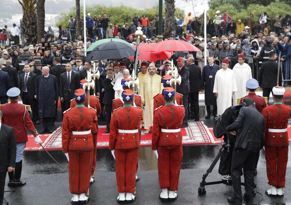 Pope Francis and Moroccan King Mohammed VI review the honor guard in Rabat, Morocco, Saturday, March 30, 2019. Francis's weekend trip to Morocco aims to highlight the North African nation's tradition of Christian-Muslim ties while also letting him show solidarity with migrants at Europe's door and tend to a tiny Catholic flock on the peripheries. (AP Photo/Gregorio Borgia)