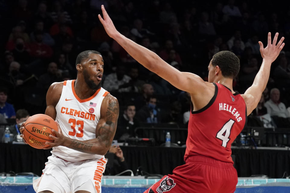 Clemson Tigers' Naz Bohannon (33) looks to pass against North Carolina State's Jericole Hellems (4) during the first half of an NCAA college basketball game of the Atlantic Coast Conference men's tournament, Tuesday, March 8, 2022, in New York. (AP Photo/John Minchillo)