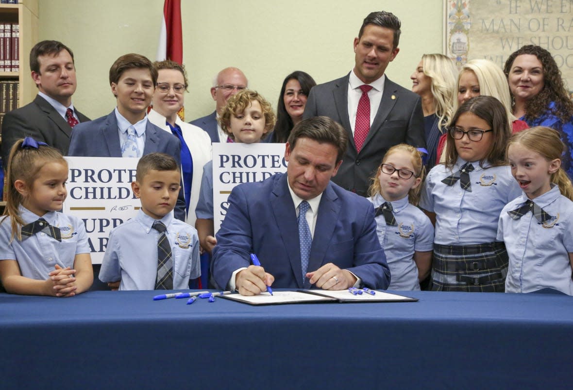 Florida Gov. Ron DeSantis signs the Parental Rights in Education bill at Classical Preparatory school on March 28, 2022, in Shady Hills, Fla. (Douglas R. Clifford/Tampa Bay Times via AP, File)