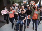 <p>Cristina Jiminez, left, and Ady Barkan, in wheelchair, lead a small delegation to the office of California Democratic Sen. Dianne Feinstein, urging the Democrats to protect the Deferred Action for Childhood Arrivals (DACA) program in Los Angeles, Jan. 3, 2018. (Photo: Reed Saxon/AP) </p>