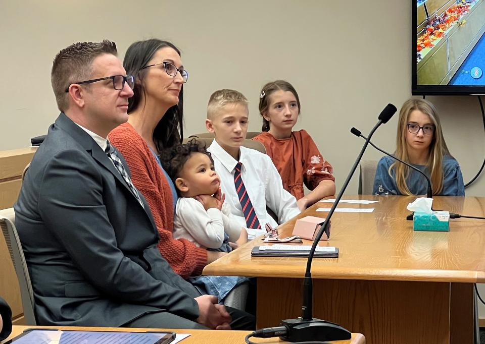 The Millers listen during Ottawa County's Adoption Day Ceremony on Tuesday, Nov. 22, 2022. Russell and Amy Miller officially adopted Gracelynn, whom they'd been fostering.