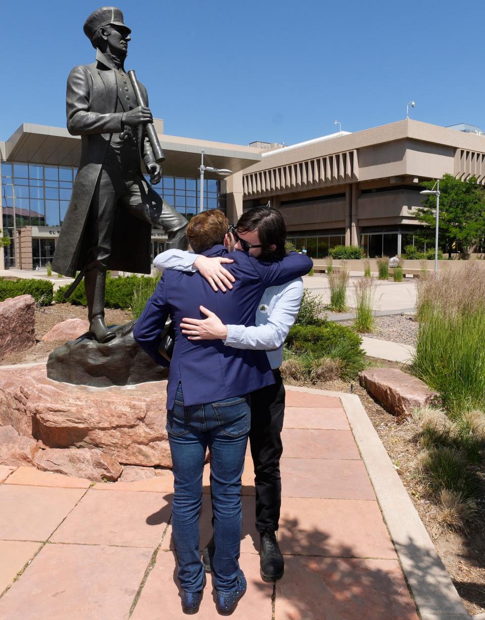 Michael Anderson, front, vice presient of operations at Club Q, hugs his brother, Tim, after a hearing Monday, June 26, 2023, in the case of the mass shooting at the LGBTQ nightclub. The attack left five people dead just before Thanksgiving Day 2022 in Colorado Springs, Colorado.