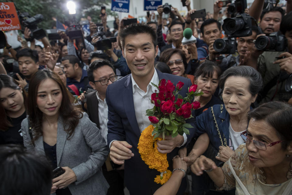 Thanathorn Juangroongruangkit, center, leader of the anti-military Future Forward Party is surrounded by his supporters on his arrival at Constitutional Court in Bangkok, Thailand, Wednesday, Nov. 20, 2019. Thanathorn is expected to receive a verdict whether he is eligible to remain as a member of the parliament due to an accusation of owning media shares a violation of the Thai constitution. (AP Photo/Gemunu Amarasinghe)