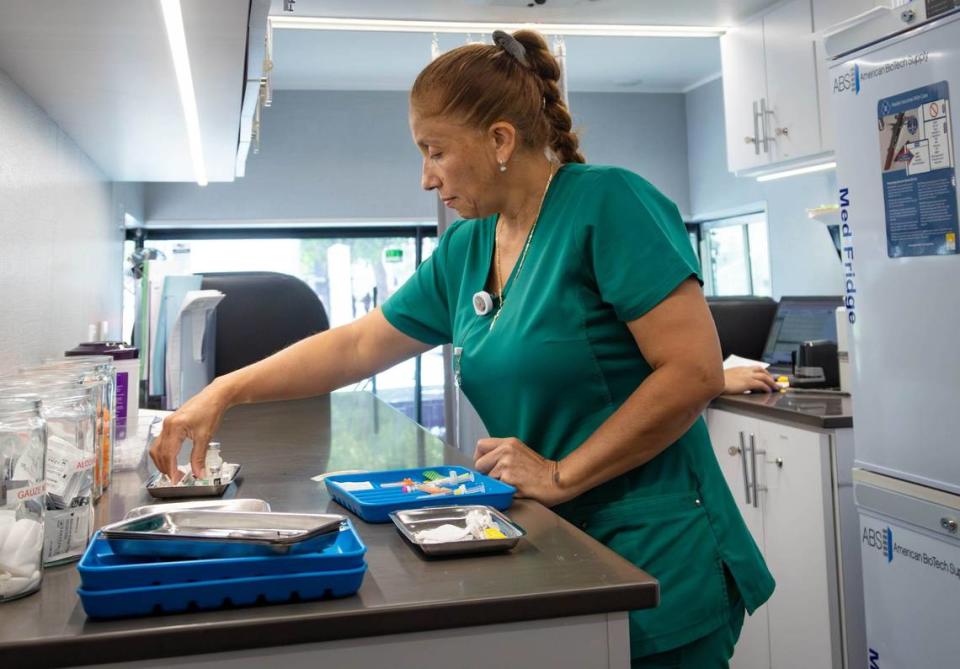 Pediatrician Karen Mendez prepares a vaccine inside the SHOTZ-2-GO mobile pediatric vaccination unit outside of the Uhealth Jackson Metro Station, formerly known as the Civic Center, on Friday, July 12, 2024 in Miami, Fla.
