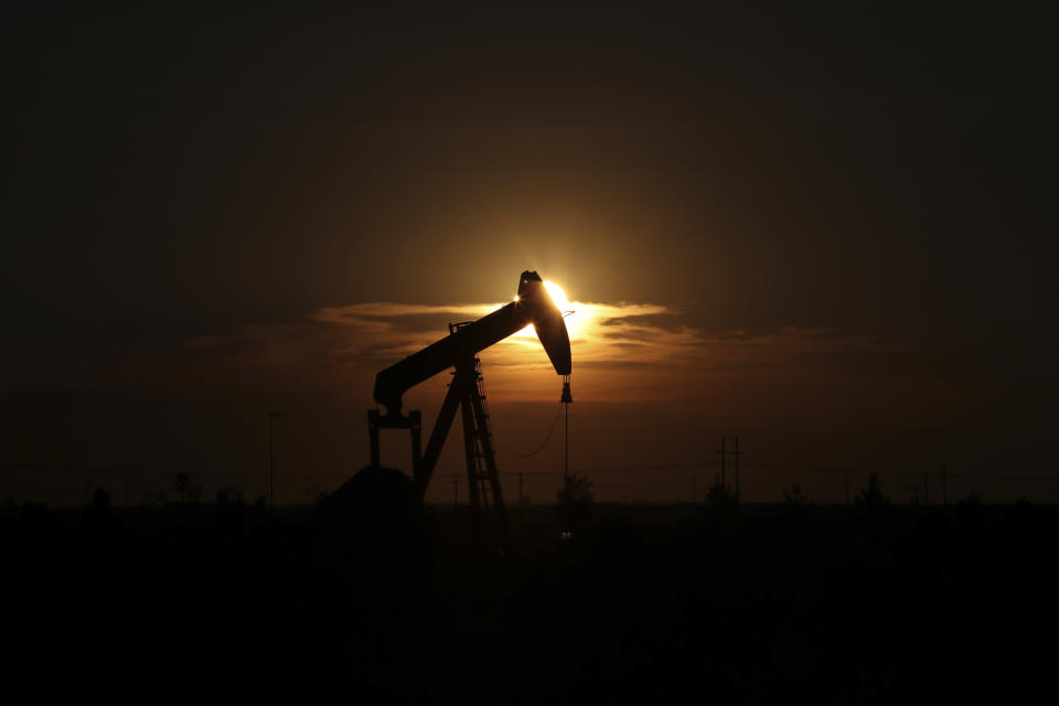 This June 27, 2017, file photo shows an oil rig at sunset in Midland, Texas. (Steve Gonzales/Houston Chronicle via AP)