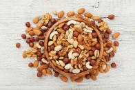 <p>Peanuts, almonds, pecans and other types of nuts are nutritional powerhouses. They’re filled with vitamins, minerals and healthy fats with health benefits ranging from preventing weight gain and avoiding heart problems to <a href="https://www.thedailymeal.com/healthy-eating/foods-neurologists-eat-brain-health?referrer=yahoo&category=beauty_food&include_utm=1&utm_medium=referral&utm_source=yahoo&utm_campaign=feed" rel="nofollow noopener" target="_blank" data-ylk="slk:protecting your brain;elm:context_link;itc:0;sec:content-canvas" class="link ">protecting your brain</a>. Walnuts are particularly beneficial to women, as they have been linked to warding off and even helping to improve the health of patients with breast cancer. If you don’t like snacking on raw nuts, try incorporating all-natural nut butters into your weekly diet.</p>