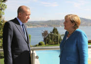 Turkish President Recep Tayyip Erdogan, left, and German Chancellor Angela Merkel talks to each otherat Huber Villa presidential palace ahead of their meeting, in Istanbul, Saturday, Oct. 16, 2021. Merkel and Erdogan are expected to discuss Ankara's relationship with Germany and the European Union as well as regional issues including Syria and Afghanistan. The chancellor's trip is one of her last before she leaves her position. (Turkish Presidency Pool via AP)