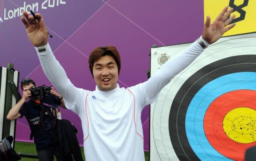 South Korea's Im Dong-Hyun celebrates breaking his own 72-arrow world record in the archery ranking round with a score of 699 at the Lord's Cricket Ground in London on July 27. Legally-blind Im scored 699 points from 72 arrows to beat his own record of 696 set in May this year