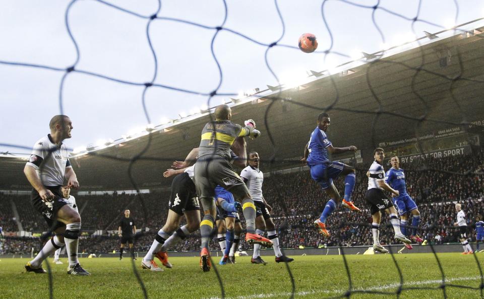 Chelsea's John Mikel Obi (3rd R) heads and scores his goal against Derby County during their English FA Cup soccer match at the iPro Stadium in Derby, central England January 5, 2014. REUTERS/Darren Staples (BRITAIN - Tags: SPORT SOCCER TPX IMAGES OF THE DAY)