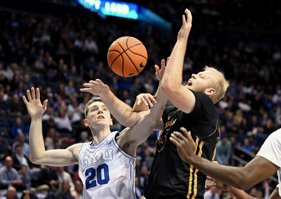 Brigham Young Cougars guard Spencer Johnson (20) battles Southeastern Louisiana Lions forward Brody Rowbury (15) for the rebound as BYU and SE Louisiana play at the Marriott Center in Provo on Wednesday, Nov. 15, 2023. | Scott G Winterton, Deseret News