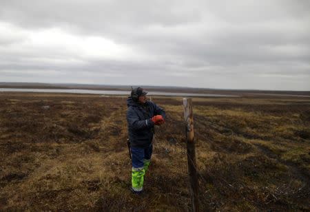 Sami reindeer herder Nils Mathis Sara, 60, repairs a fence used by herders in the Finnmark Plateau, Norway, June 15, 2018. REUTERS/Stoyan Nenov/Files