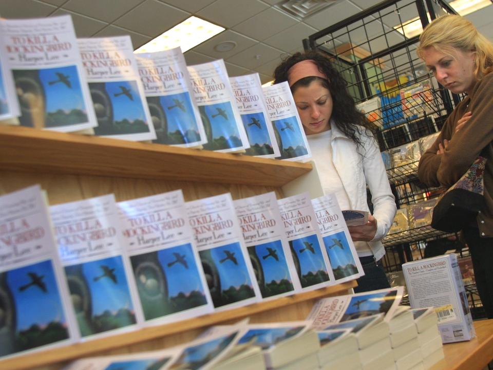 Copies of "To Kill A Mockingbird" displayed on shelves