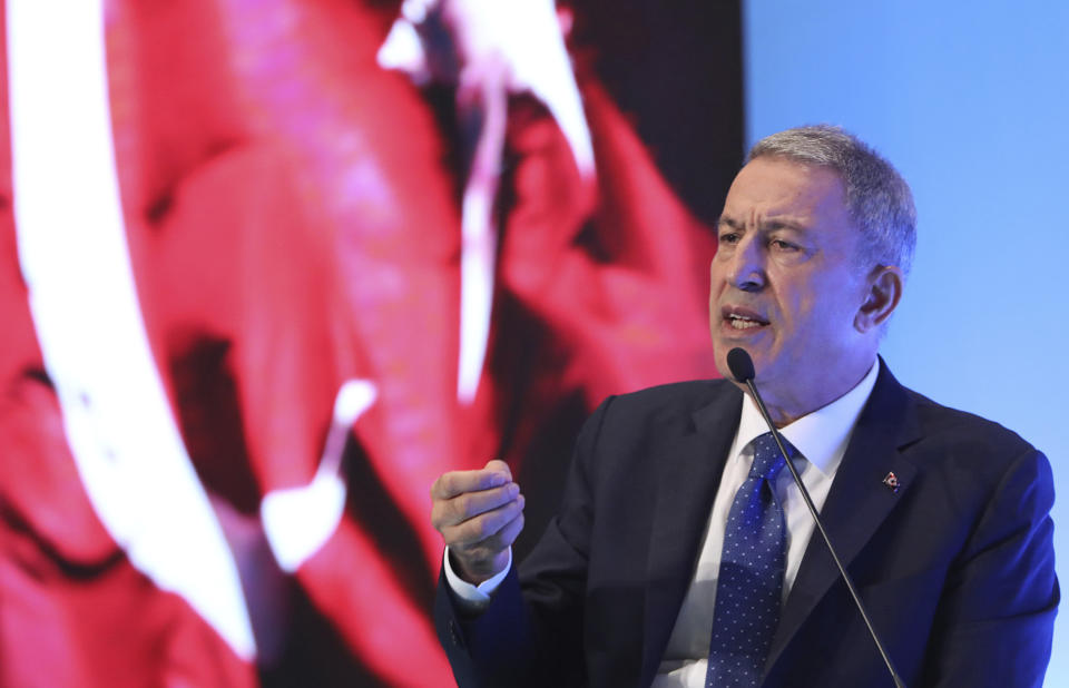 Turkey's Defense Minister Hulusi Akar addresses a meeting of his country's ambassadors, in Ankara, Turkey, Wednesday, Aug. 7, 2019. Akar says his country would like to establish a safe zone in northeast Syria jointly with the United States but would act alone if necessary. (Turkish Defence Ministry via AP, Pool)