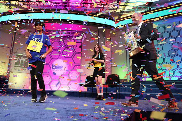 NATIONAL HARBOR, MARYLAND - JUNE 01:  Speller Dev Shah of Largo, Florida, is presented with a trophy by E. W. Scripps Company CEO Adam Symson after he won the 2023 Scripps National Spelling Bee at Gaylord National Hotel and Convention Center on June 1, 2023 in National Harbor, Maryland. Shah correctly spelled the word 