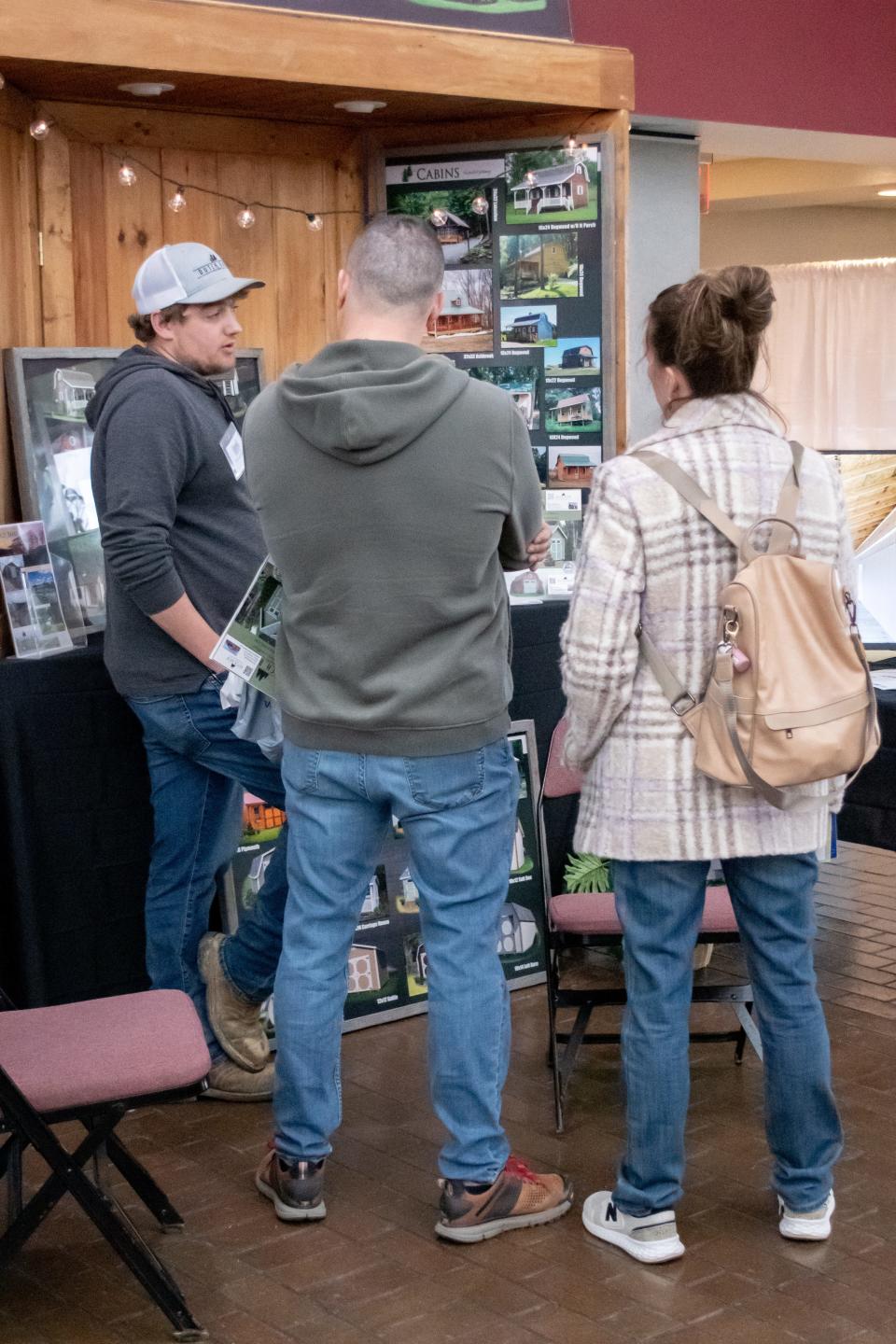 Guests at the 2023 Home, Garden, and Business Expo take some time to speak with Dutch Barn Builders.