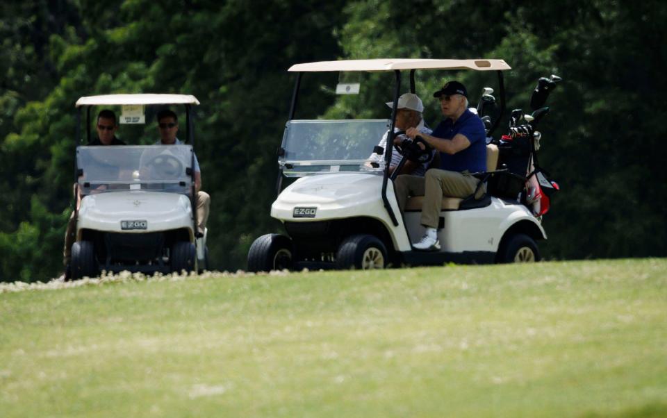 Joe Biden drives a golf cart with his brother James Biden on the golf course at Joint Base Andrews, MD, US