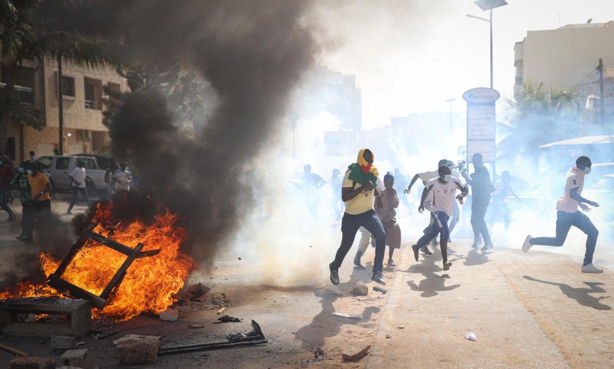 <span>Supporters of opposition presidential candidates set tyres and tables on fire in Dakar following the indefinite postponement of Senegal's presidential election, which was due to be held on 25 February.</span><span>Photograph: Cem Özdel/Getty</span>