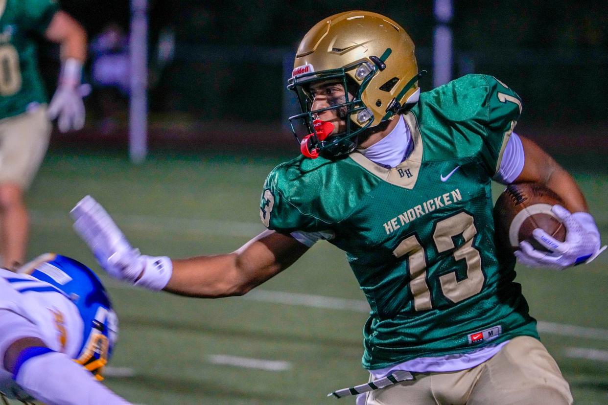 Michael DaSilva Jr. fends off blockers on his way to first-down yardage against Kellenberg Memorial on Friday night.