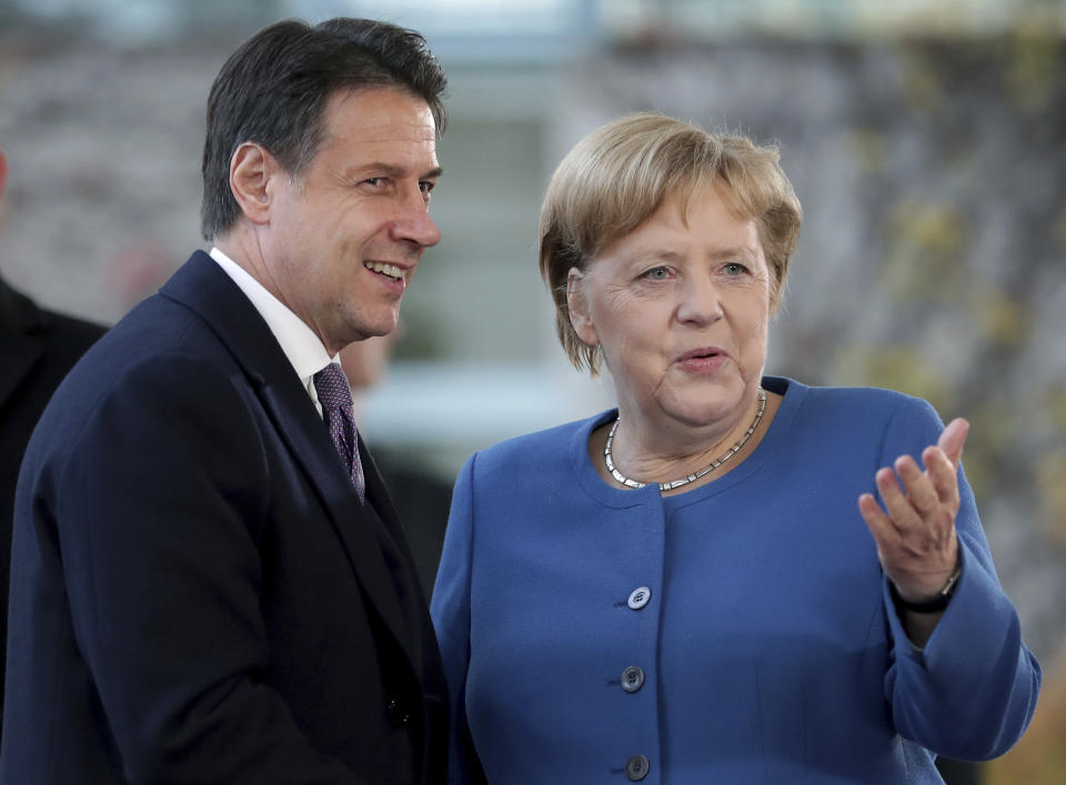 FILE - In this Tuesday, Nov. 19, 2019 file photo, German Chancellor Angela Merkel, right, and Italy's Prime Minister Giuseppe Conte, left, shake hands prior to a meeting at the chancellery as part of the 'Compact with Africa' conference in Berlin, Germany. When Giuseppe Conte exited the premier’s office, palace employees warmly applauded in him appreciation. But that’s hardly likely to be Conte’s last hurrah in politics. Just a few hours after the handover-ceremony to transfer power to Mario Draghi, the former European Central Bank chief now tasked with leading Italy in the pandemic, Conte dashed off a thank-you note to citizens that sounded more like an ’’arrivederci″ (see you again) then a retreat from the political world he was unexpectedly propelled into in 2018.(AP Photo/Michael Sohn, File)